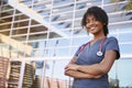 Portrait of smiling black female healthcare worker outdoors