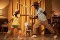 Black little girl in sword fight with father on stage Royalty Free Stock Photo