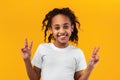 Portrait of smiling black teen girl showing peace sign Royalty Free Stock Photo