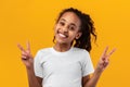Portrait of smiling black teen girl showing peace sign Royalty Free Stock Photo