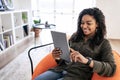 Portrait of smiling black woman using digital tablet at home Royalty Free Stock Photo