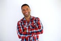 Smiling black young man with arms crossed standing against white background Royalty Free Stock Photo