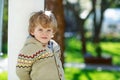 Portrait of smiling blond preschool boy, outdoors Royalty Free Stock Photo