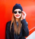 Portrait smiling blonde woman wearing fashion rock black style over red Royalty Free Stock Photo