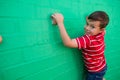 Portrait of smiling boy climbing wall at playground Royalty Free Stock Photo