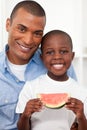 Portrait of a smiling boy eating fruit