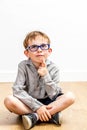 Portrait of smiling boy with eyeglasses thinking for child innocence