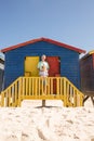 Portrait of smiling boy with grandfather standing at beach hut