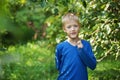 Portrait smiling boy on the green background, outdoors Royalty Free Stock Photo