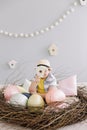 Portrait of a smiling boy in a hat. Easter composition with birds nest, easter eggs, dry willow branches. Royalty Free Stock Photo