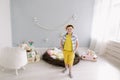 Portrait of a smiling boy in a hat. Easter composition with birds nest, easter eggs, dry willow branches. Royalty Free Stock Photo