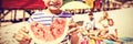 Portrait of smiling boy holding watermelon with family in background Royalty Free Stock Photo