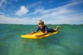 Happy boy lay on surf board smiling and looking at camera Royalty Free Stock Photo
