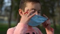 Portrait of smiling boy looking camera outdoors. Masked child posing camera. Royalty Free Stock Photo