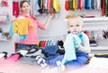Portrait smiling boy with mother in kid store Royalty Free Stock Photo