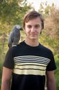 Portrait smiling boy with a parrot . Royalty Free Stock Photo