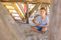 Portrait of smiling boy playing with sand while sitting under hut Royalty Free Stock Photo