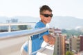 Portrait of a smiling boy stands on the balcony Royalty Free Stock Photo