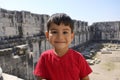 Portrait of smiling boy in the temple of Apollo.