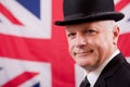 Smiling British businessman city worker with Union Jack flag background.