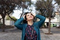 Portrait of a smiling brunette girl of twenty five years old dressed in a vintage blue dress with a pattern and a green blouse Royalty Free Stock Photo