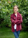 Portrait of smiling brunette teenage girl in apple orchard Royalty Free Stock Photo