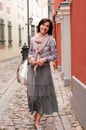 Portrait of smiling brunette woman in town