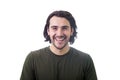 Portrait of smiling brunette young man, long curly hair style, looking joyful and laughing to camera isolated on white background Royalty Free Stock Photo