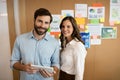 Portrait of smiling business colleagues working on digital tablet Royalty Free Stock Photo