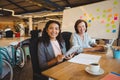 Portrait of smiling business executives using laptop and digital tablet Royalty Free Stock Photo