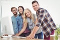 Portrait of smiling business people working at computer desk Royalty Free Stock Photo