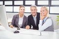 Portrait of smiling business professionals working at computer desk Royalty Free Stock Photo