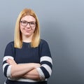 Portrait of a smiling business woman against gray background Royalty Free Stock Photo