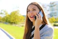 Portrait of smiling business woman having a conversation on her cell phone outdoors Royalty Free Stock Photo