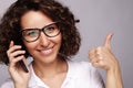 Portrait of smiling business woman phone talking and show OK