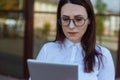 Portrait of smiling business woman using tablet pc in front of office building. Royalty Free Stock Photo