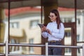 Portrait of smiling business woman using tablet pc in front of office building. Royalty Free Stock Photo