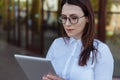 Portrait of smiling business woman using tablet pc in front of office building. Royalty Free Stock Photo