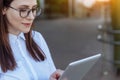 Portrait of smiling business woman using tablet pc in front of office building. Royalty Free Stock Photo