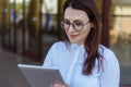 Portrait of smiling business woman using tablet pc in front of office building. Royalty Free Stock Photo