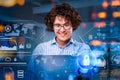 Portrait of smiling businessman in glasses is sitting in front of laptop at abstract office space, white and blue glowing Royalty Free Stock Photo