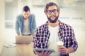 Portrait of smiling businessman holding coffee cup and digital tablet Royalty Free Stock Photo