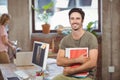 Portrait of smiling businessman holding files and folders in creative office Royalty Free Stock Photo