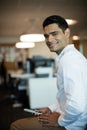 Portrait of smiling businessman holding mobile phone Royalty Free Stock Photo