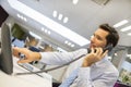 Portrait of smiling businessman at phone in office