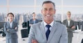 Portrait of smiling businessman standing ahead of businesswomen at modern office Royalty Free Stock Photo
