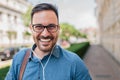 Portrait of smiling businessman wearing eyeglasses listening music on headphones Royalty Free Stock Photo