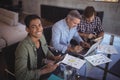 Portrait of smiling businessman working with coworkers at creative office Royalty Free Stock Photo