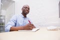 Portrait of a smiling businessman writing notes Royalty Free Stock Photo