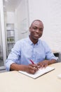 Portrait of a smiling businessman writing notes Royalty Free Stock Photo